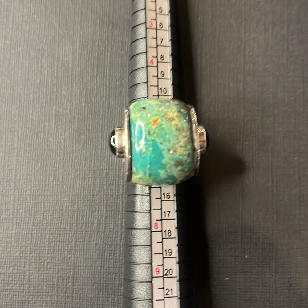 Modern chrysocolla ring with onyx stone cabochons on the sides.